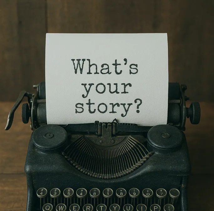 typing machine with “What’s your story?” written on paper